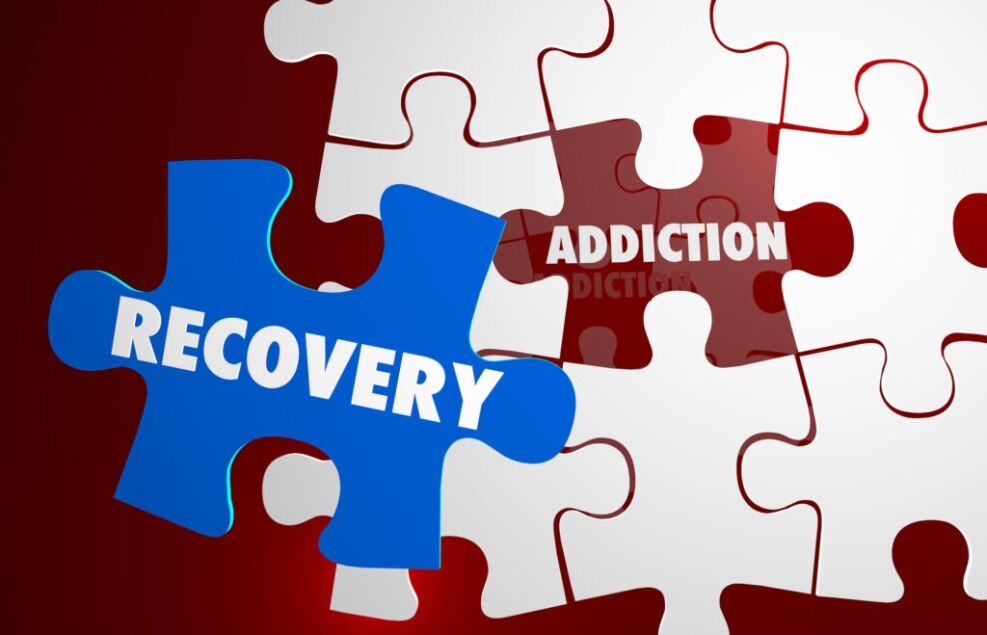the words "addiction and recovery" inserted into puzzle pieces.